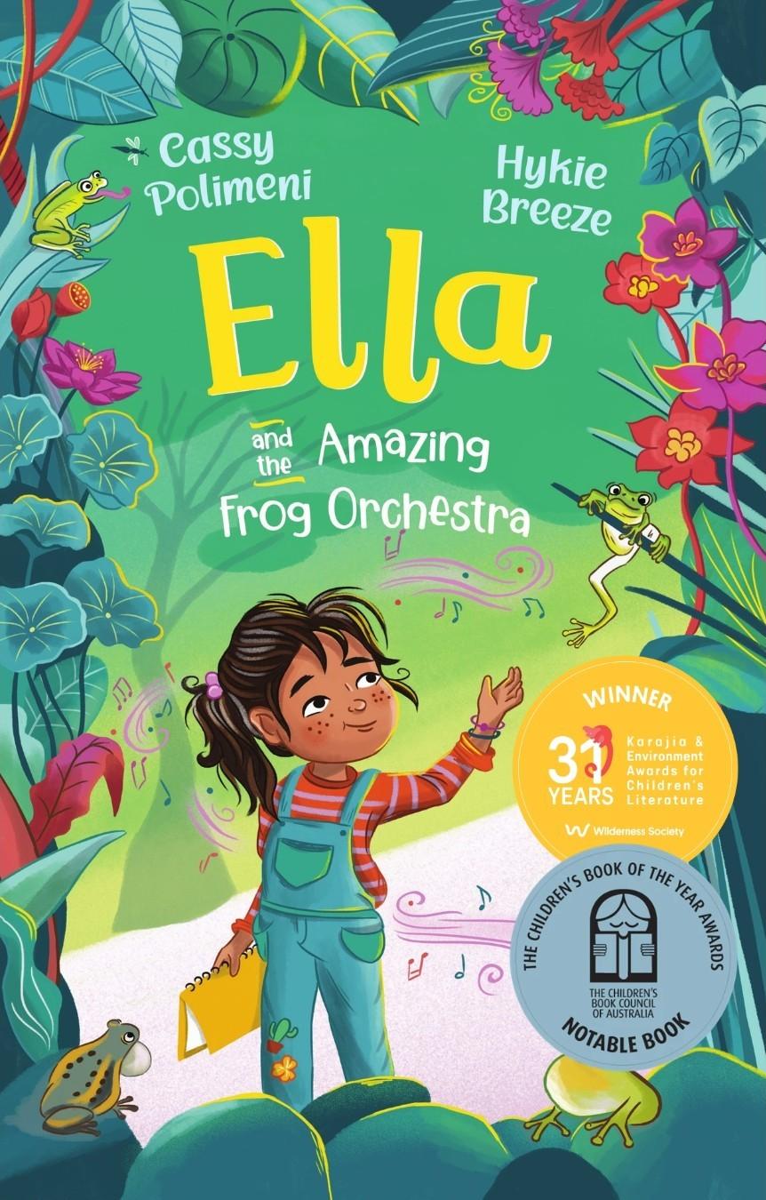 This is the cover for ‘Ella and the Amazing Frog Orchestra’ Written by Cassy Polimeni and illustrated by Hykie Breeze. The cover shows a girl walking in a forest with frogs around her. She is carrying a book as musical notes circle her.